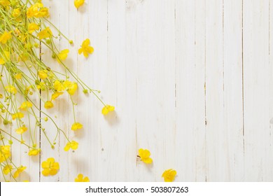 Yellow Flowers On Wooden Background