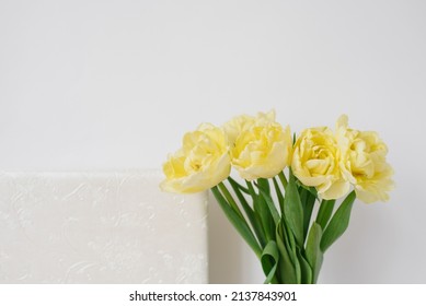 Yellow Flowers Tulips On The Background Of A White Wedding Or Family Photo Book. Fond Memories In Photographs For Memory