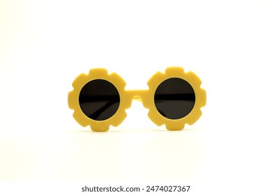 yellow flower-shaped sunglasses on a white background