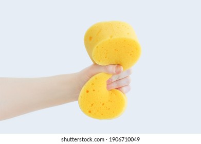 Yellow Foam Sponge Washcloth Clenched In The Hand Of A Caucasian Woman.