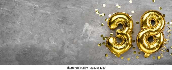 Yellow foil balloon number, number thirty eight on a concrete background. Greeting card with inscription 38. Anniversary concept. for anniversary, birthday, new year celebration. banner, copy space. - Shutterstock ID 2139584939