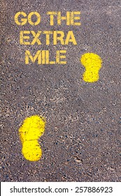 Yellow Footsteps On Sidewalk.Go The Extra Mile Message.Concept Image