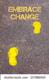 Yellow footsteps on sidewalk.Embrace Change message.Concept image