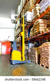 Yellow Forklift Loading Goods In Cold Warehouse