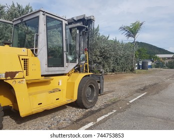 Yellow Forklift Working Outside On Road Works.