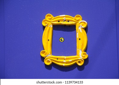 Yellow frame or peephole on blue door - Shutterstock ID 1139734133