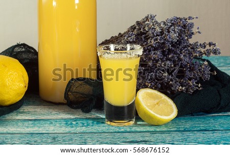 Yellow fresh shot cocktail or lemonade with lemon.