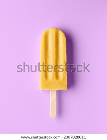 Yellow fruit popsicle on light purple background, top view. Mango, banana, passion fruit and pineapple flavor