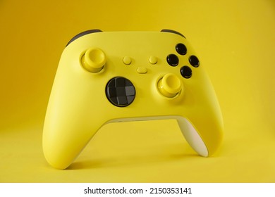 Yellow game controller on Yellow background