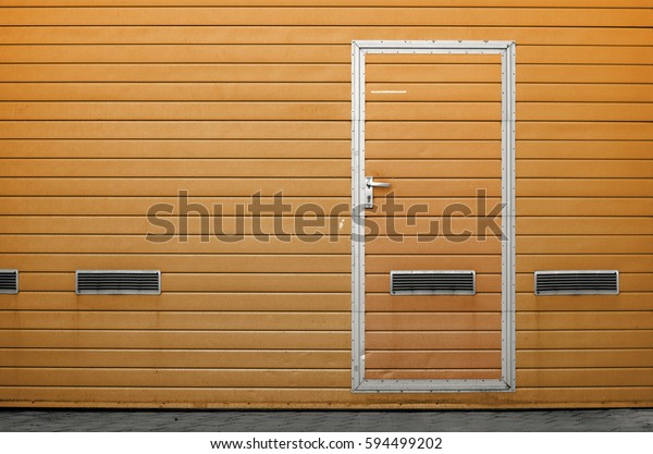 Yellow garage gate with ventilation\
grilles. Large automatic up and over garage door with inclusion of\
smaller personal door. Multicolor background\
set
