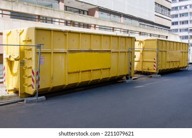 Yellow Garbage Containers Near The Building, Construction Site On The Background. Recycling, Construction Waste, Dumpster Near Construction Site