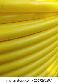 Yellow Gas Hose That Is Being Rolled Up And Ready To Be Used For Housing Gas Installation.