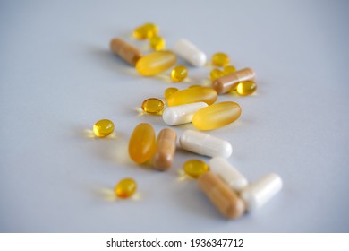 Yellow gel transparent gel nutraceutical capsules of vitamin d or omega 3 in spoon.