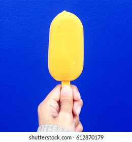Yellow Gold Ice-cream Popsicle On Vivid  Cobalt Blue Background