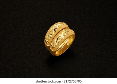 yellow gold rings photo. gold jewelry on the black background.