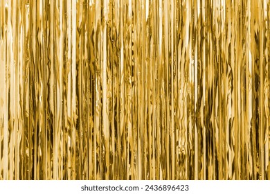 Yellow golden foil strip blurred abstract background. Curtain hanging on wall. Festive, Christmas, New Year or anniversary party concept. Decorative wallpaper