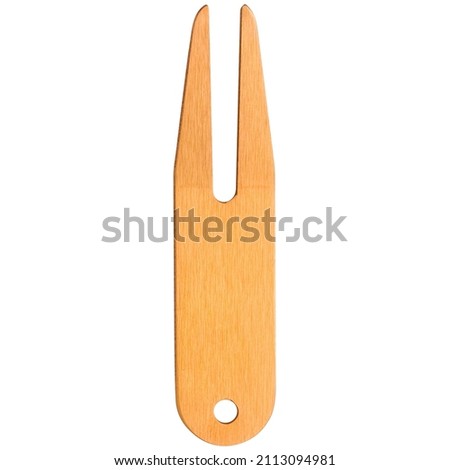 Yellow golf divot tool or replacer on white background. Closeup.