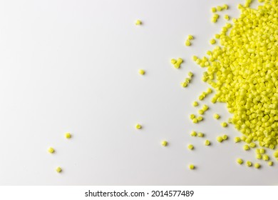 Yellow granules of polypropylene or polyamide on a white background. Plastics and polymers industry. Copy space