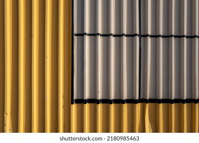 Yellow, Gray, And Black Corrugated Metal Wall.