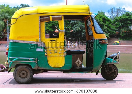 Yellow and green auto rickshaw 