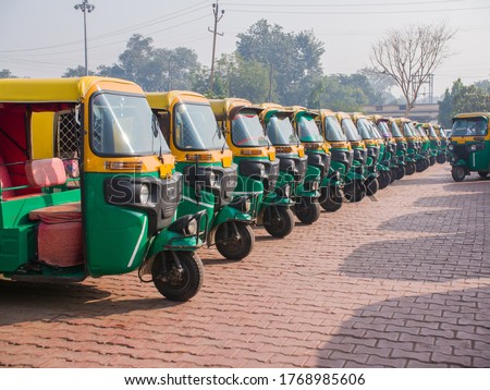 Yellow and green auto rickshaws in Indiya.