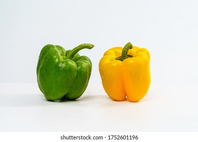 Yellow and Green Bell Pepper Wet from Spray Water Drop on Isolated White Background.