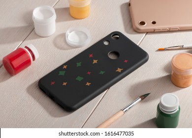 Yellow, Green And Red Stars Painted On Black Phone Case. Beautiful Handmade Art For Mobile Accessory.