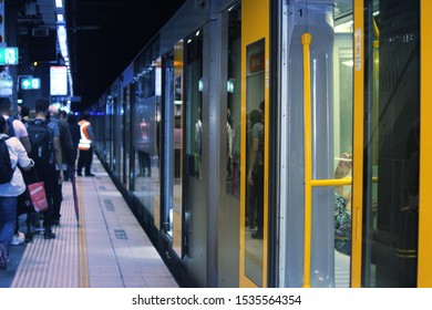 Yellow And Grey Train With Its Doors Open On A Crowded Platform In An Underground Tunnel. Wynyard Sydney