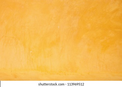 Yellow grunge cement wall, textured background