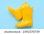 Yellow gumboots on blue background