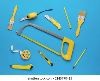 Yellow Hand Tool On A Bright Blue Background For Creativity. The Concept Of Repair And Construction. Flat Lay.