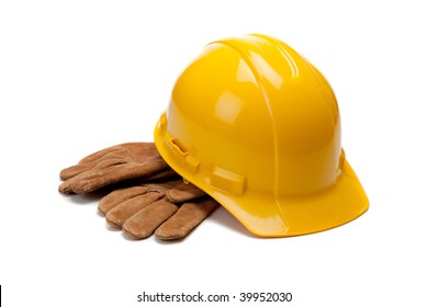 A Yellow Hard Hat And Leather Work Gloves On A White Background
