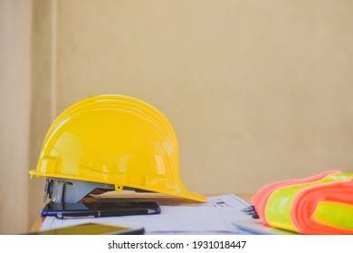 Yellow hard hat safety for engineering on desk in office