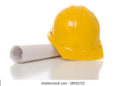 A Yellow Hard Hat And A Set Of Blue Prints On A White Background