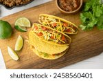 yellow hard shell tacos  on cutting board