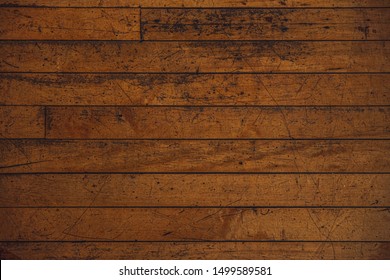 Yellow Hard Wood Floor Pattern With Scuff Marks And Other Wear