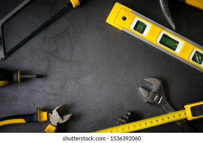 Yellow Hardware Tools On Black Concrete Background With Some Space For Text