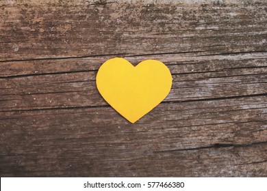 Yellow Heart On Wooden Background