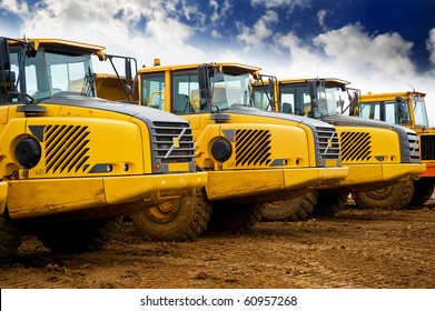 Yellow heavy construction tipper trucks