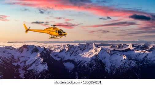 Yellow Helicopter flying over the Rocky Mountains. Dramatic Sunrise. Aerial Landscape from British Columbia, Canada near Vancouver. Composite. Canadian Panoramic Nature Background