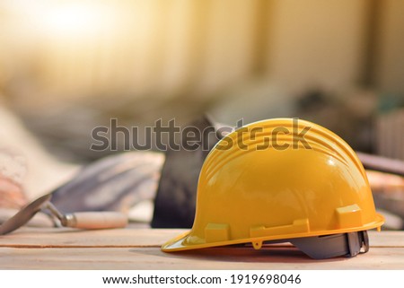 Yellow helmet hard hat  on wood floor in constriction site Foto d'archivio © 
