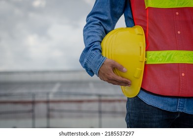 Yellow helmet hard hat safety in the hands of construction engineer. - Shutterstock ID 2185537297
