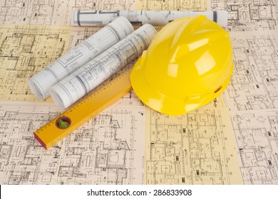 Yellow helmet, level and project drawings  - Shutterstock ID 286833908