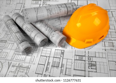 Yellow helmet and project drawings  - Shutterstock ID 1126777631