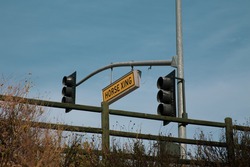 Yellow Horse Crossing Sign Next To Street Light