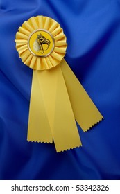 Yellow Horse Show Ribbon Shot On Silky, Shiny, Blue Material