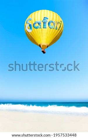 Yellow hot air balloon with the inscription 