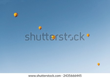 Yellow hot air balloons in the sky at sunrise. Cappadocia, Turkey. Bottom up view
