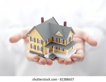 Yellow house in hands