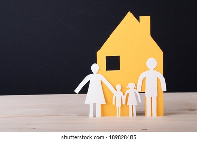 A Yellow House With A White Paper Chain Family